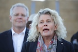 Fiona Simson speaks at a press conference with Prime Minster Scott Morrison watching on over her shoulder