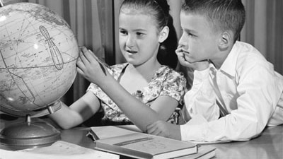 Children play with a globe