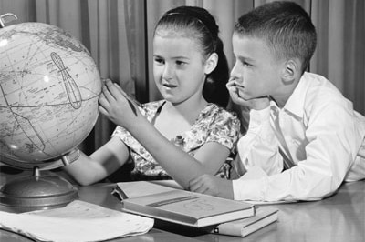 Children play with a globe