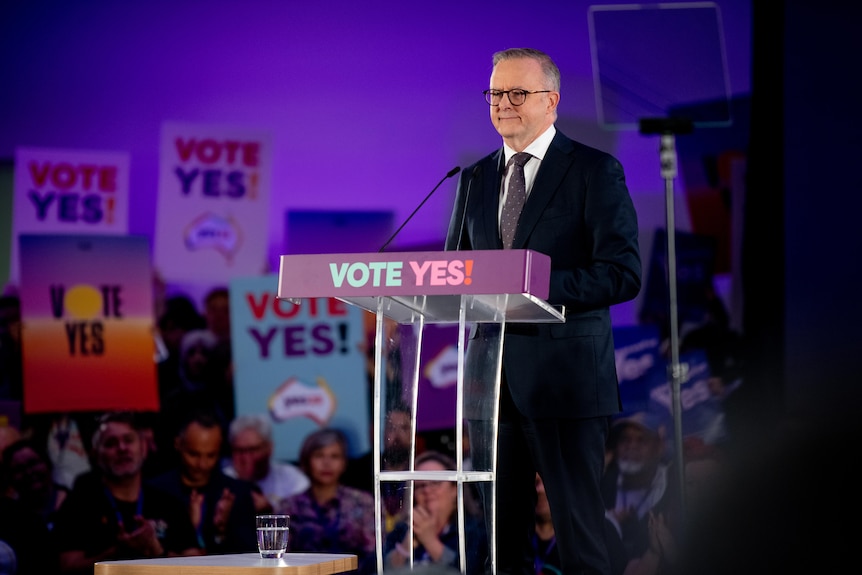 Anthony Albanese standing in front of "VOTE YES" branding as he announces the date of the Voice to Parliament referendum