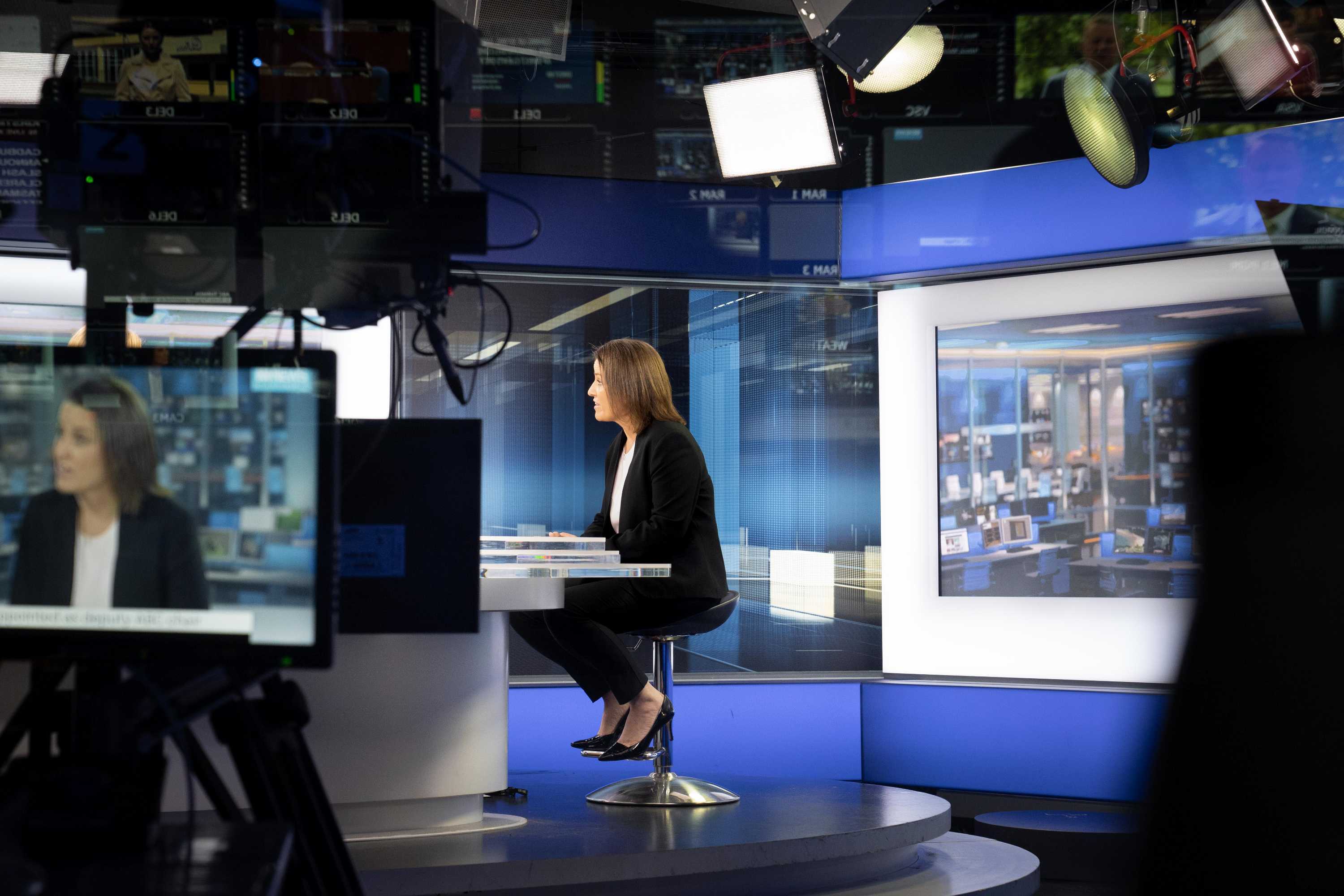 Kirstin Ferguson at the interview desk and on a camera screen