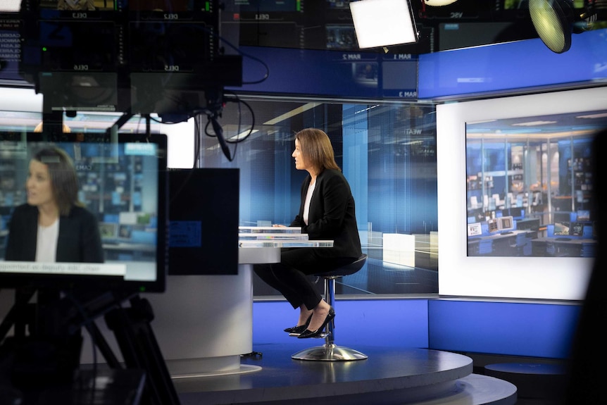 Kirstin Ferguson at the interview desk and on a camera screen