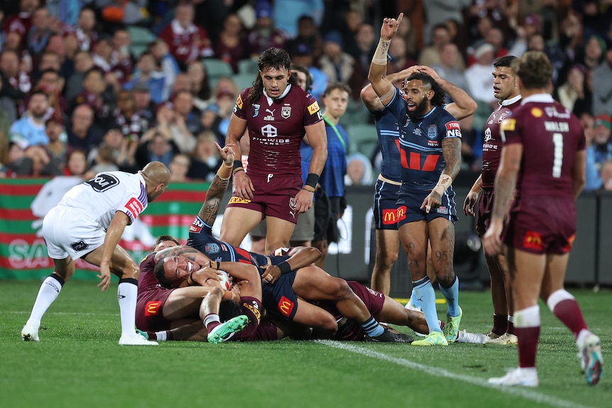 Tyson Frizell is held up over the line