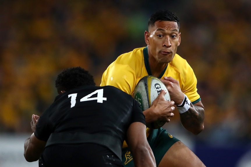 Israel Folau runs with the ball into an All Black