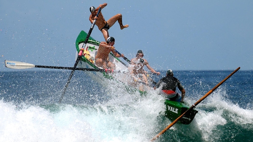 The Mona Vale surf boat crew in the under-23 men's division get airborne.