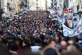 Large crowd of people marching through a street in France