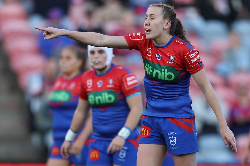 A Newcastle Knights NRLW player gives instructions during a match. 