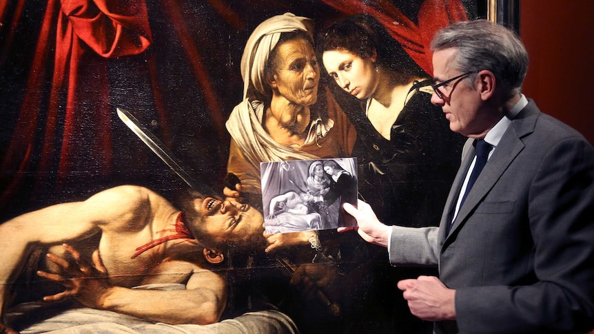 French art expert Stephane Pinta shows an x-ray image of the painting during its presentation.
