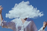 A person standing with their arms raised and their head replaced with a cloud.