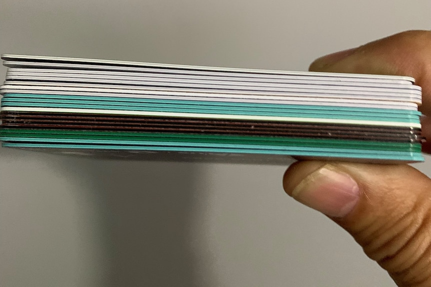 A stack of 20 credit and debit cards