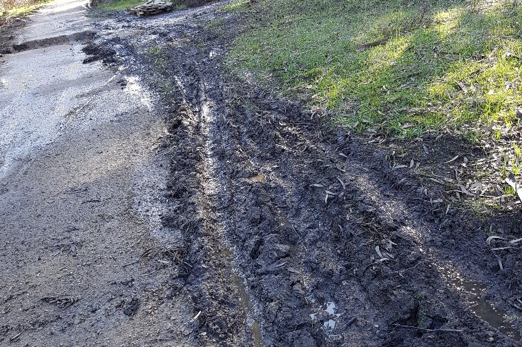 Ruts in the side of the new track.