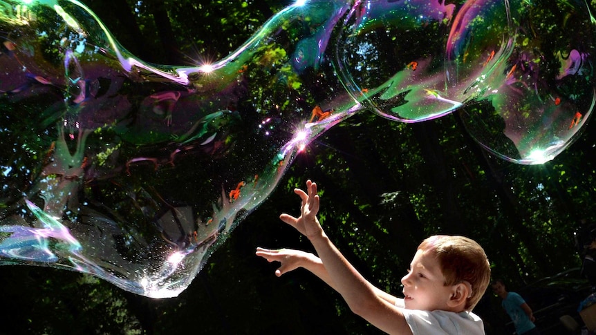 A child plays with soap bubbles.