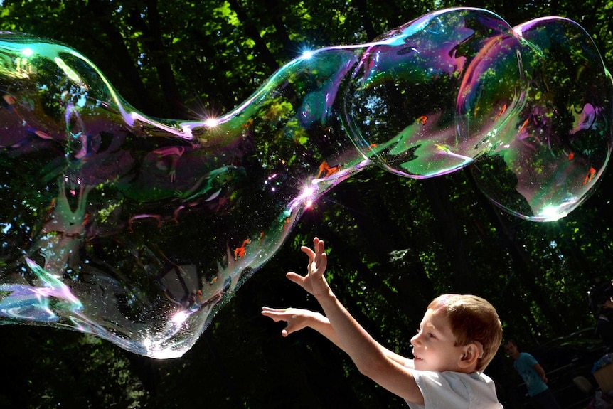 A child plays with soap bubbles.