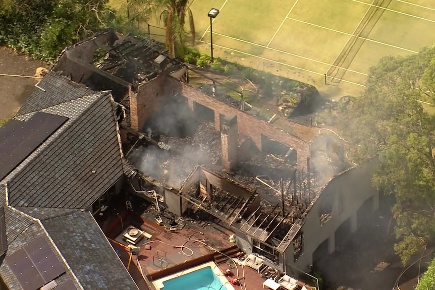 Fire-damaged house at Grose Vale in Sydney's north-west with, with pool in the middle, tennis court at the top 