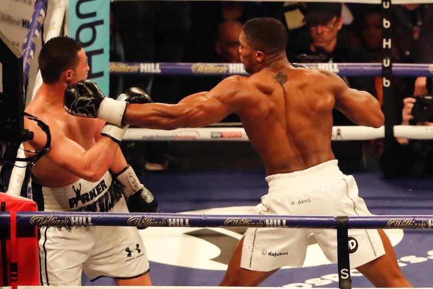 Boxer Joseph Parker against the ropes as Anthony Joshua punches him