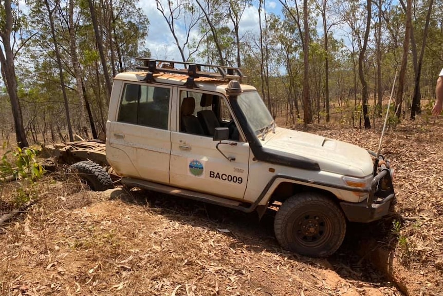 A white Toyota Landcruiser 4WD is seen smashed and damaged.