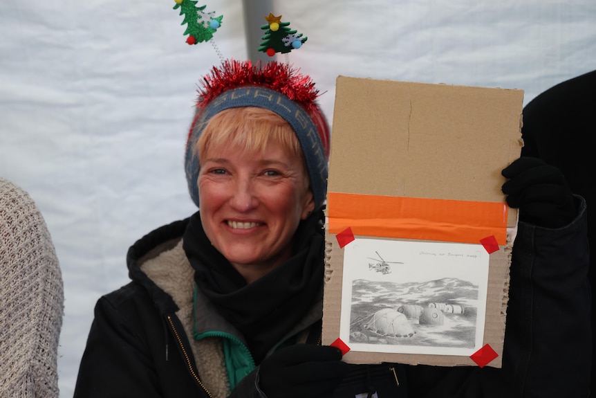 Kate Selway with sketch of camp in Christmas gear