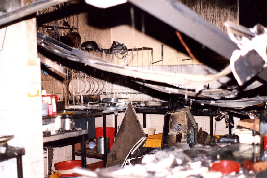 A kitchen with destroyed roof and burned walls after a firebomb attack.