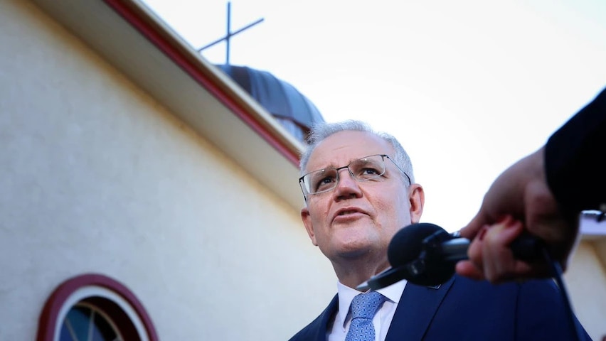 A man stands in front of a church