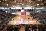 The crowd watches netballers warm-up from their seats within Netball SA Stadium