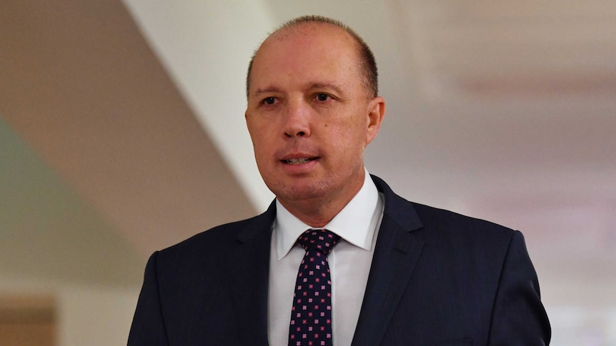 Minister for Immigration Peter Dutton arrives to a radio interview in Parliament House.