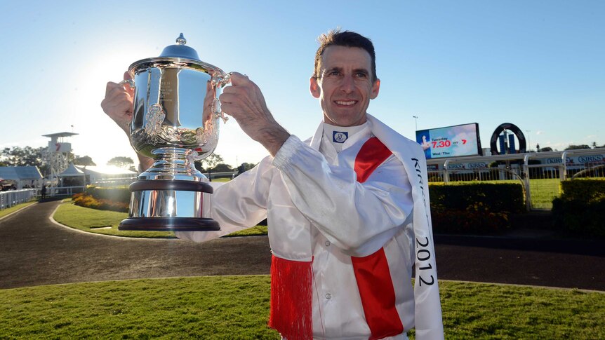 Spoils of victory ... Leith Innes celebrates winning the Doomben Cup after guiding Beaten Up to victory