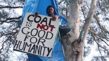 Anti-coal protesters tied themselves to trees in Brisbane