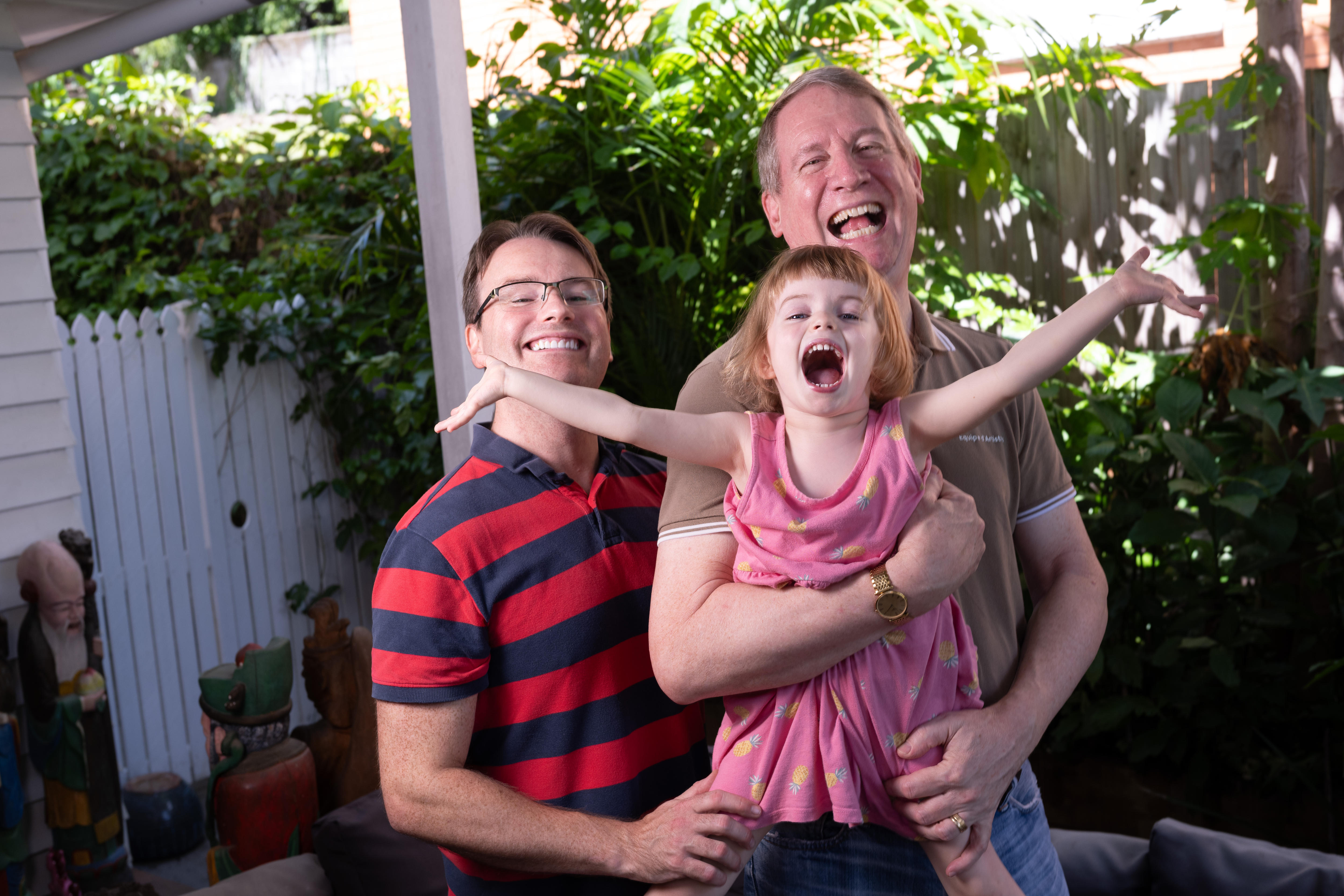 Two dads and one exuberant girl