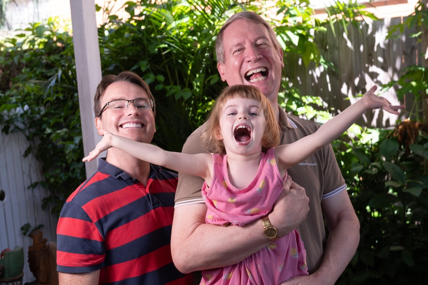 Two dads and one exuberant girl