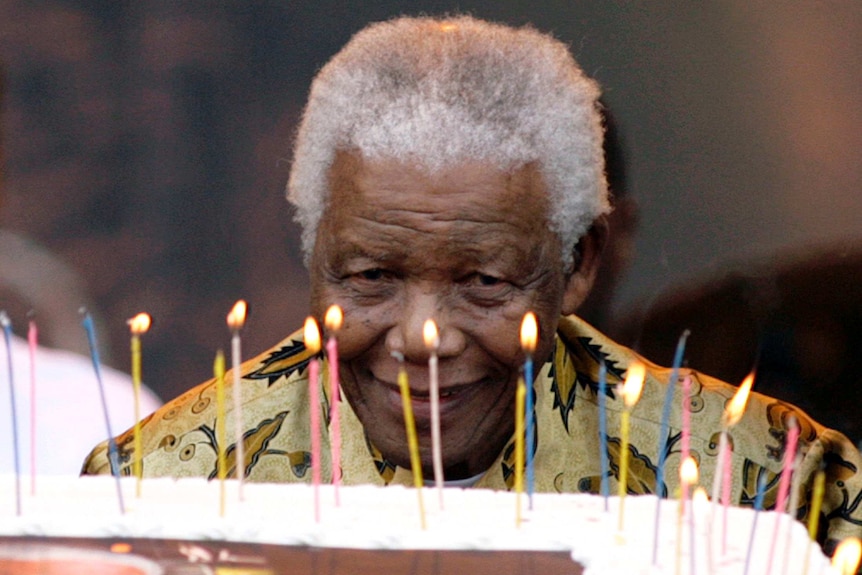 Nelson Mandela with a 90th birthday cake