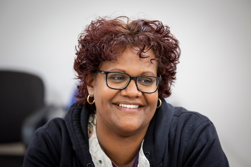 Close up of woman smiling and looking out of frame