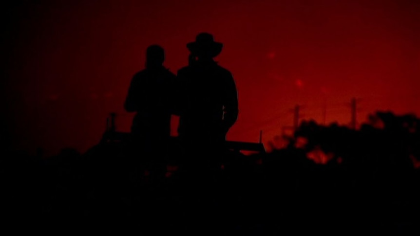 Onlookers to a fire in Stanthorpe in 2019