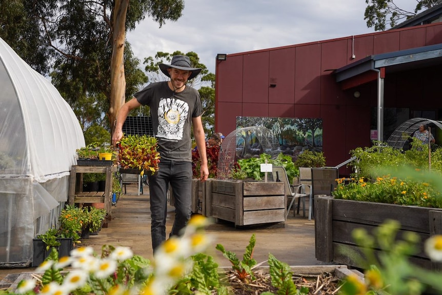 Max Godber smiles in a garden