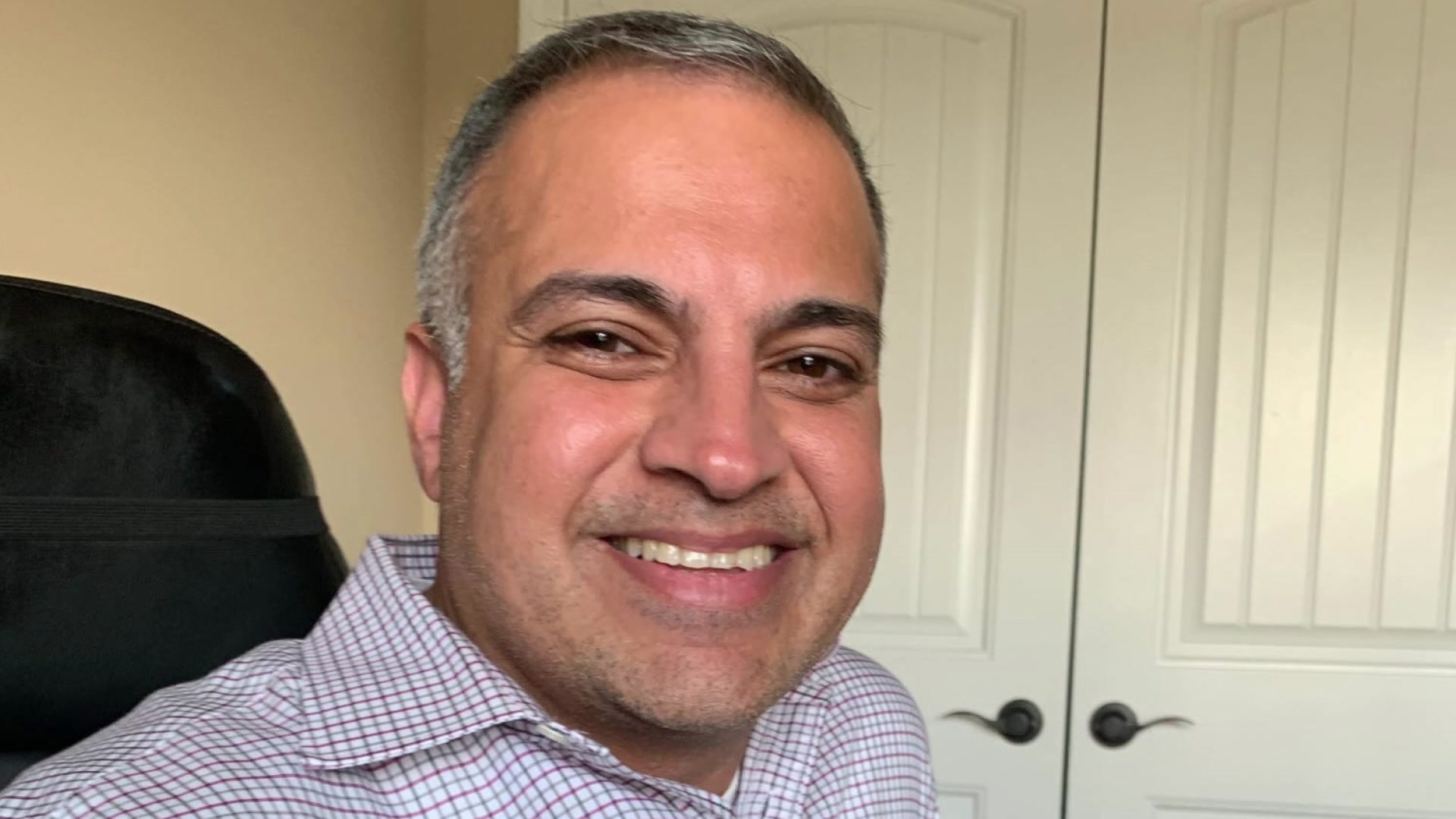 A man, smiling.