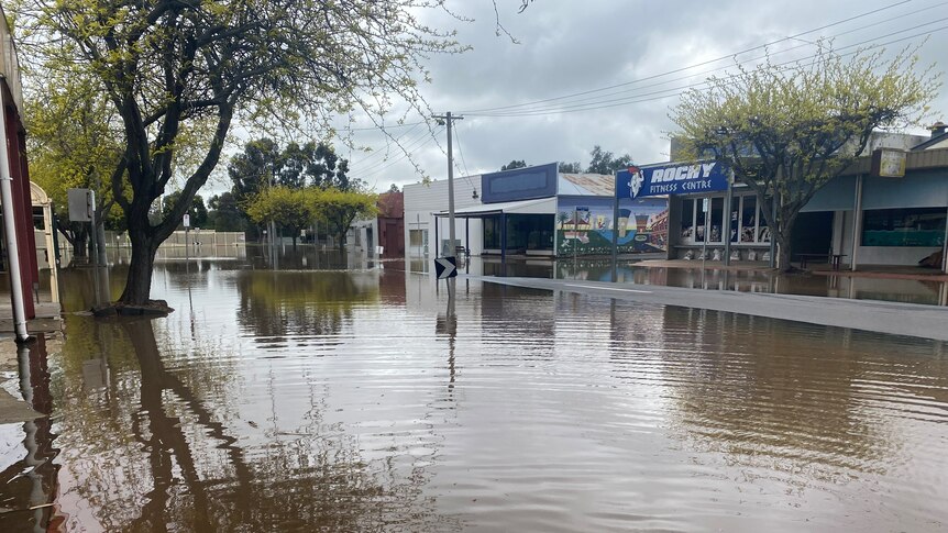 Floodwaters in the heart of Rochester, covering the road and surrounding businesses.