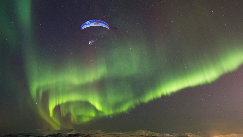 Horacio Llorens paragliding under the Aurora Borealis