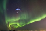 Horacio Llorens paragliding under the Aurora Borealis