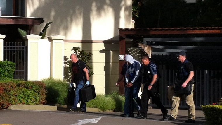 An alleged bikie is arrested in Fortitude Valley after dawn raids on Bandido branches.