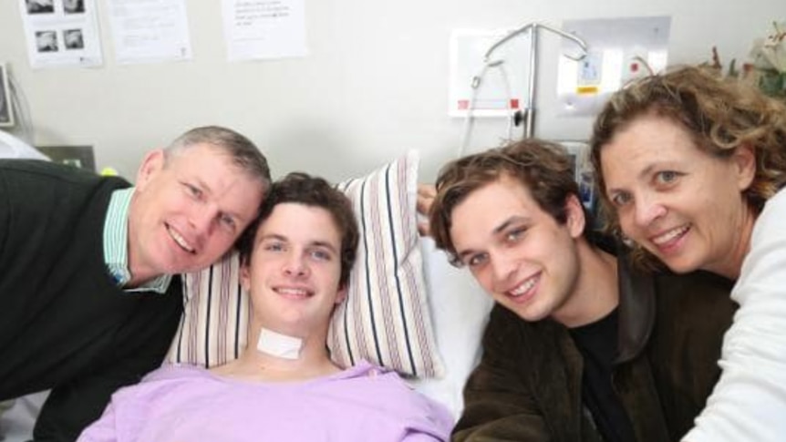 Teenager in a hospital bed with his family in Brisbane.