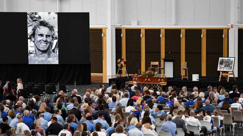 Mourners attend the memorial service for Dean Mercer