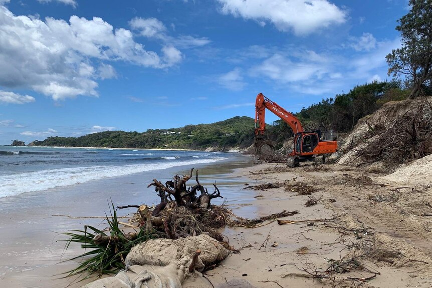 Heavy machinery is being used to clear debris and begin dune-stabilisation work at Byron Bay's Clarkes Beach.