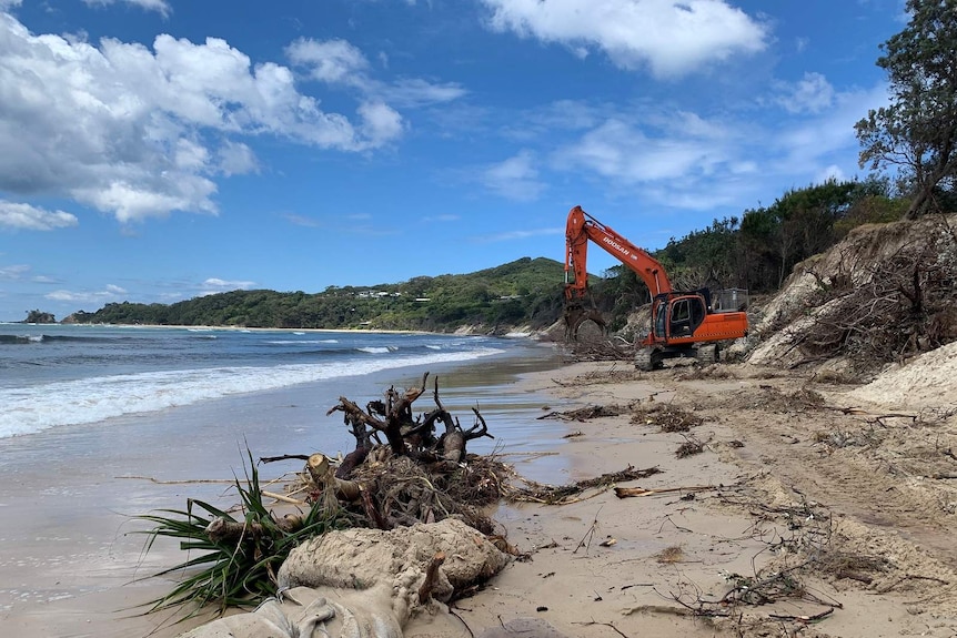 Heavy machinery is being used to clear debris and begin dune-stabilisation work at Byron Bay's Clarkes Beach.