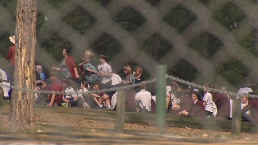 Students and staff outside a private Catholic school on Brisbane's north-west after stabbing. Thurs August 29, 2013