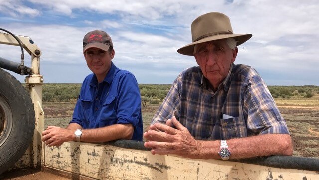 Bob and Alistair McDonald leaning on back on ute tray. 2017
