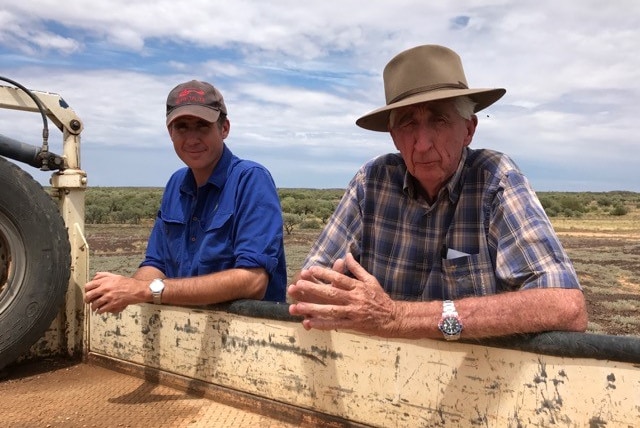 Bob and Alistair McDonald leaning on back on ute tray. 2017