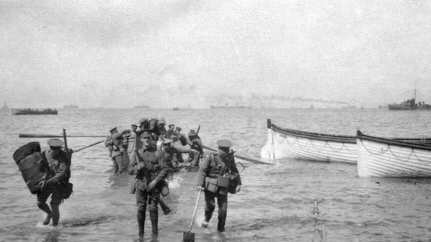 Divisional Headquarters Staff wade ashore at Anzac Cove on April 25, 1915. The officer with the spade is thought to be Major Cecil Henry Foott DAQMG (Later Brigadier CH Foott CB CMG).