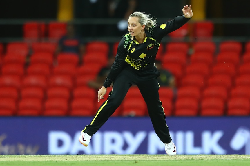 An Australian female bowler sends down a delivery against India.