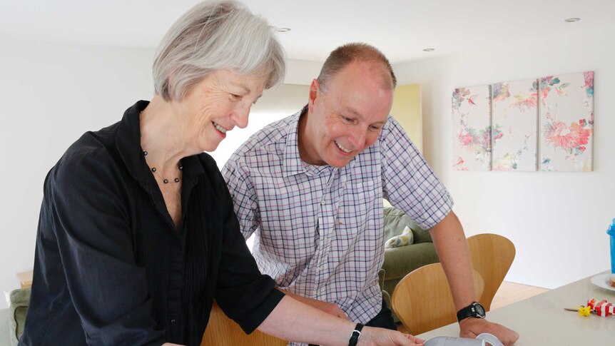 Dianne Firth from the University of Canberra and questioner Trevor Hickman look over house plans.