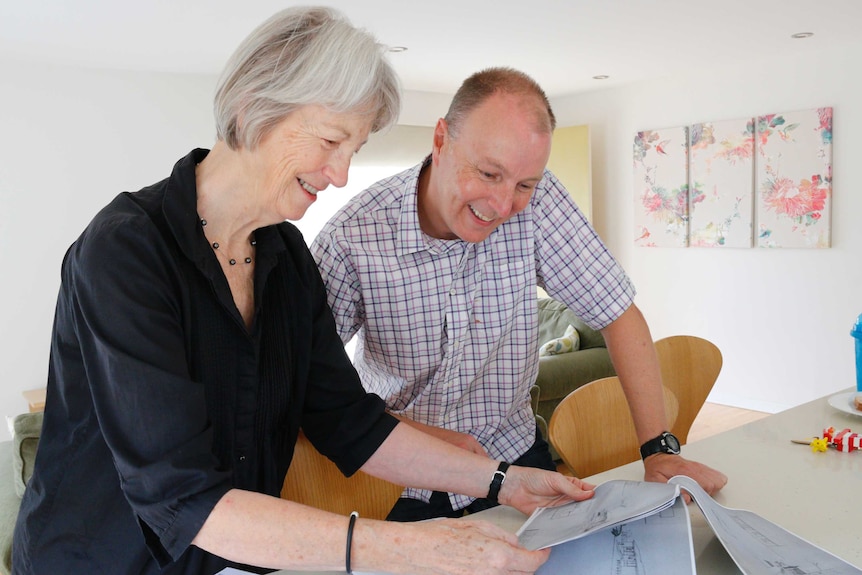 Dianne Firth from the University of Canberra and questioner Trevor Hickman look over house plans.