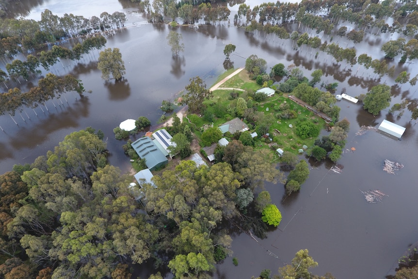 Aerial view of a house surrounded by flood water